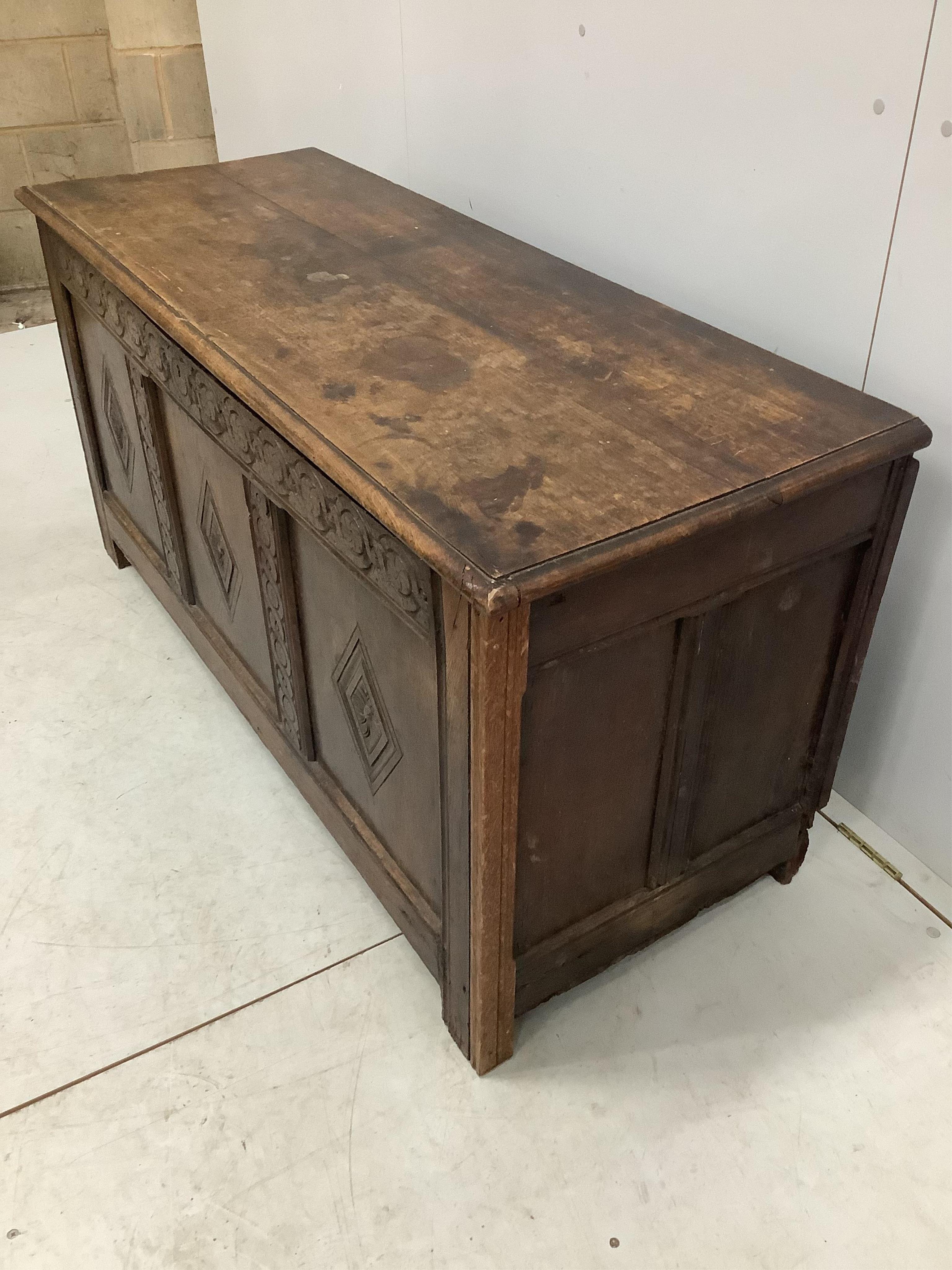 An 18th century carved oak coffer, width 141cm, depth 53cm, height 68cm. Condition - fair